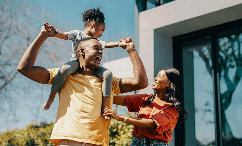 Family fun time with mom and dad at home. Couple playing with their daughter and creating happy childhood memories.
